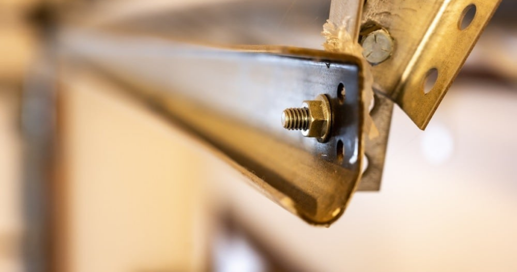 Close-up of a garage door track and bolt.