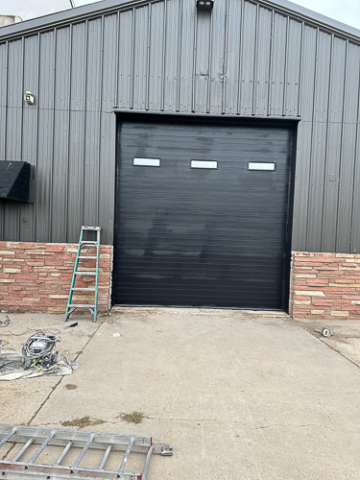 newly installed black metal garage door